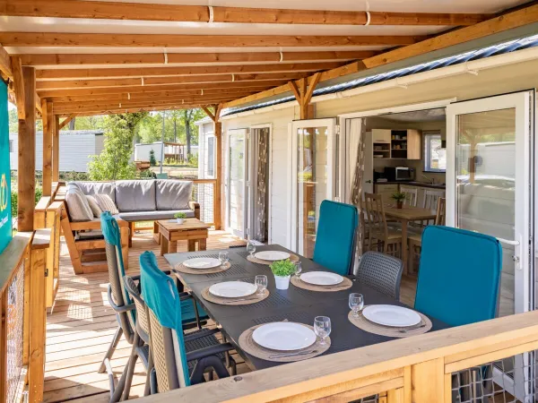 Przestronny taras w salonie Comfort Lounge wyposażony jest w stół, krzesła i wygodną sofę.