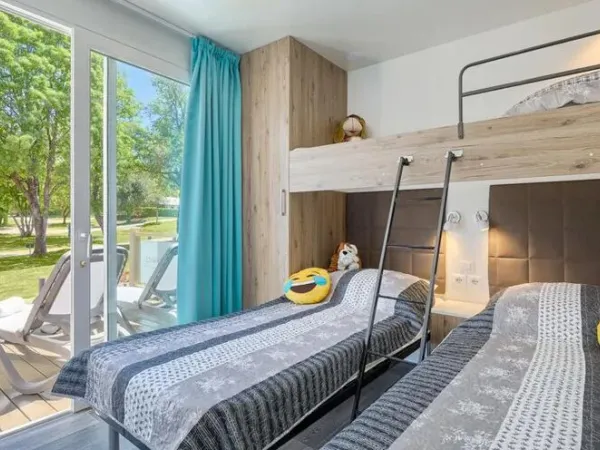 Sypialnia Roan Premium Lounge z trzema pojedynczymi łóżkami.