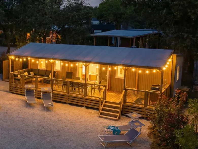 Strefa Premium Supreme Deluxe Lounge z nastrojowym oświetleniem na werandzie.